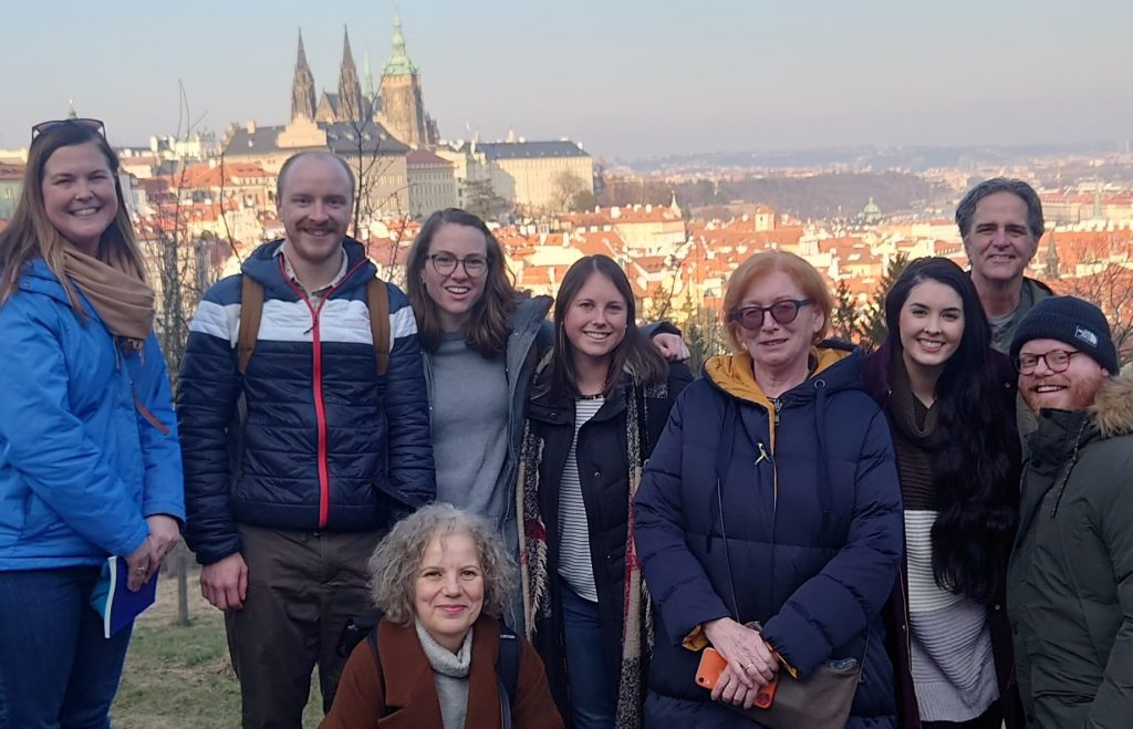 A photo of David Hicks and a cohort of Fulbright scholars and Czech Fulbright Commissioners. They are smiling and  standing on Petrin Hill in Prague, Czech Republic.
