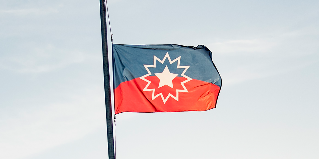 The Juneteenth flag, which is half blue and half red with a star burst in its center.
