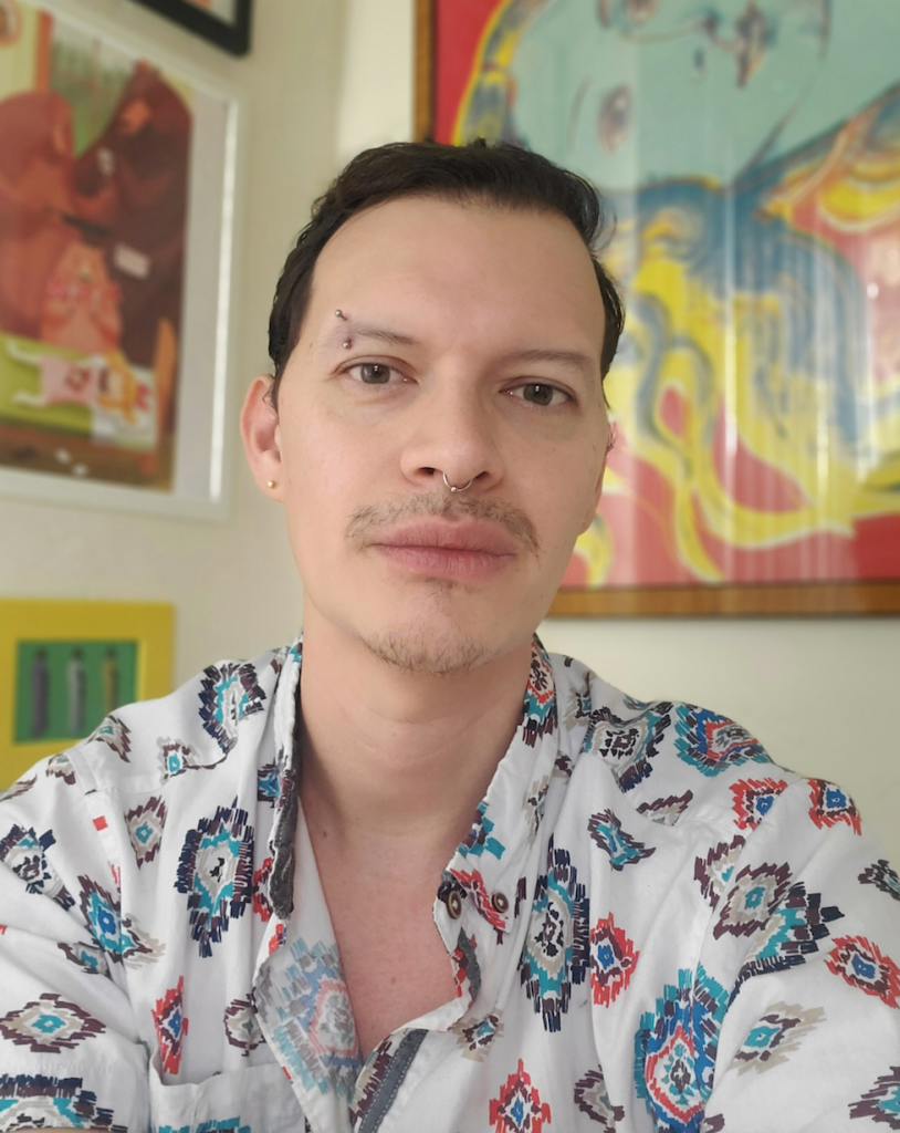 Headshot of Tim Jones wearing a multicolored shirt with a tribal design