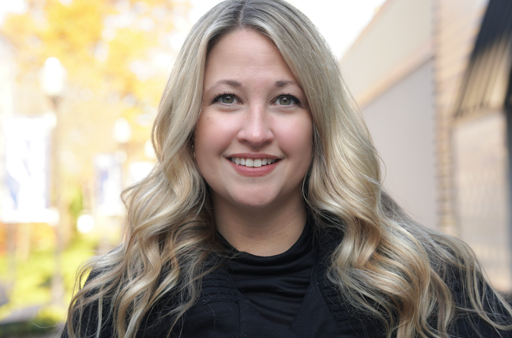 Headshot of Gabrielle D'Amico with wavy blonde hair and wearing a black shirt